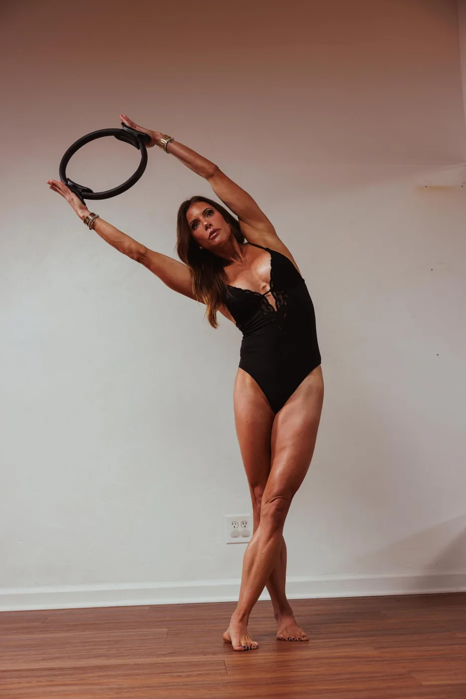 Jess leading a Pilates ring side bend at Sculpte Santa Barbara