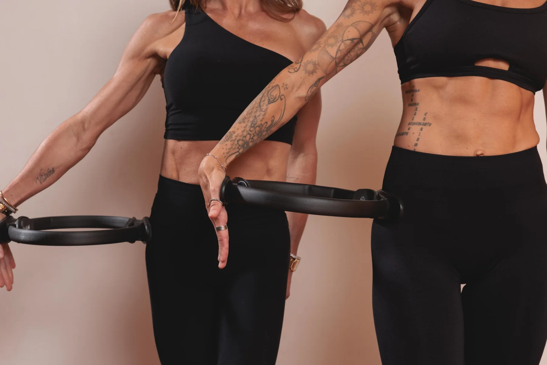 Two instructors working with Pilates rings in the Santa Barbara studio